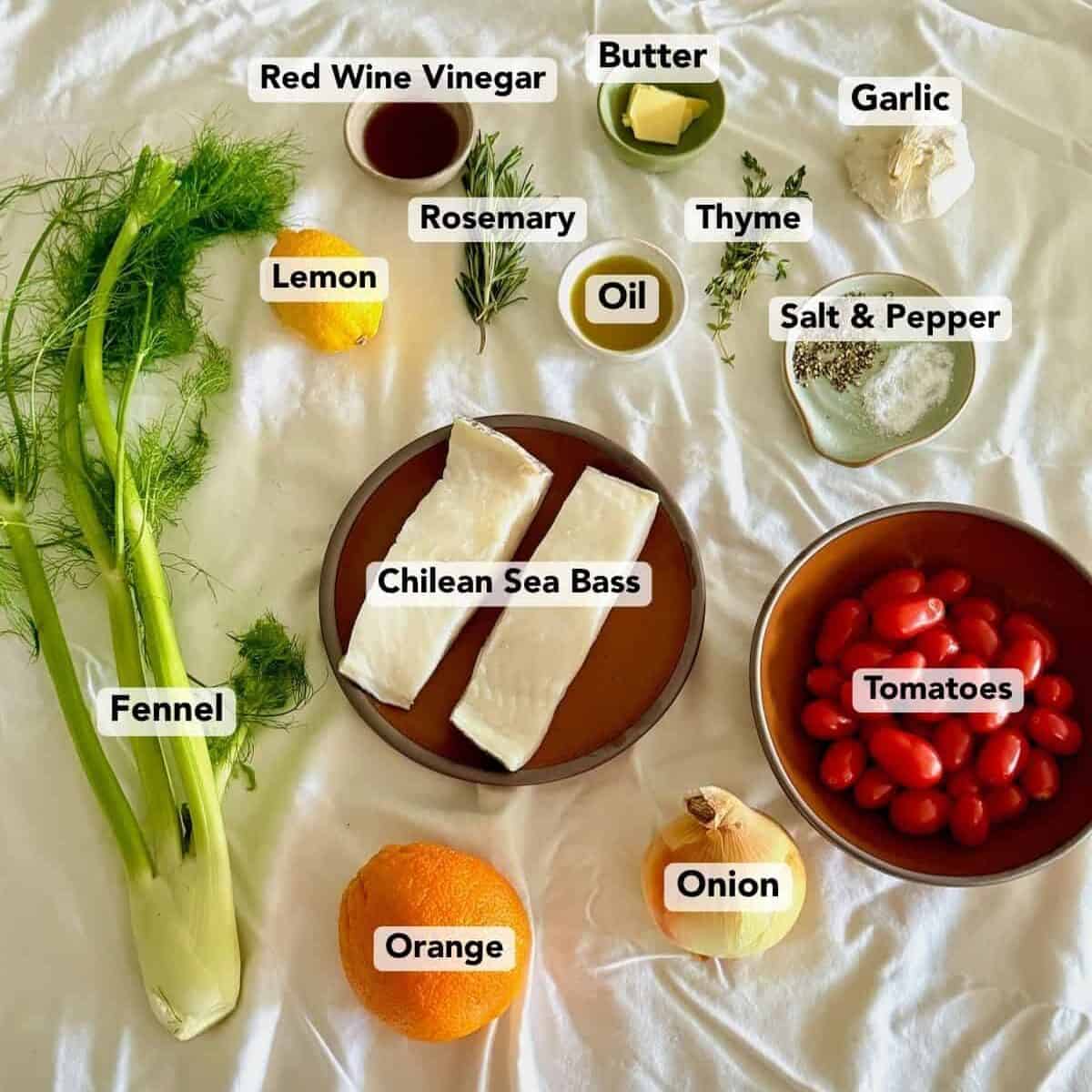 Labeled ingredients for crispy Chilean sea bass are arranged on a white cloth.